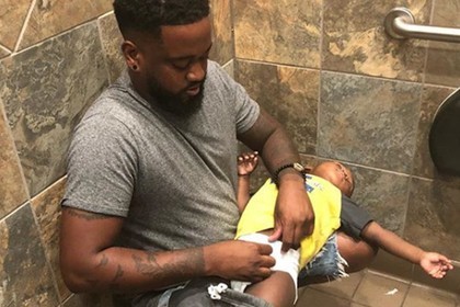 Проблему отцовства обнажил снимок мужчины с ребенком в туалете
